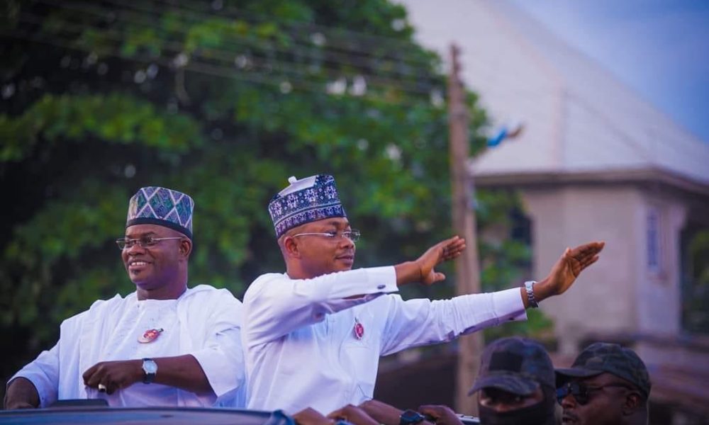 a group of men in white shirts and hats waving